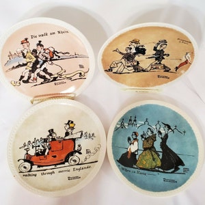 May include: Set of four decorative ceramic plates with colorful illustrations and text. The plates feature scenes of people walking in different locations, including Germany, France, England, and Italy. The text on the plates includes "Die walk am Rhein", "Promenade à Paris", "walking through merric Englande", and "When in Rome".