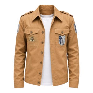 May include: Tan button-up jacket with two chest pockets and a collar. The jacket features patches on the sleeves and chest, and the text "PWPC" is visible on one of the patches. A white t-shirt is visible underneath.