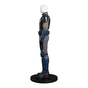 May include: A gray and blue costume displayed on a mannequin. The costume includes a gray jumpsuit, black boots, and blue armor on the shoulders, forearms, and shins. A brown belt and a patch with text are also visible.