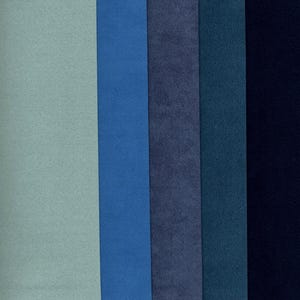 May include: A collection of six vertical rectangular fabric swatches in shades of blue and green. The colors range from light teal to deep navy, with varying textures. The swatches are arranged side by side, showcasing a palette of cool tones.