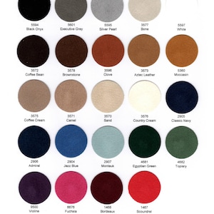 May include: A color chart titled ULTRASUEDE ST featuring twenty-four circular fabric swatches in various shades including black, grey, white, brown, blue, green, red, and purple. Each swatch is labeled with a numerical code and a color name.