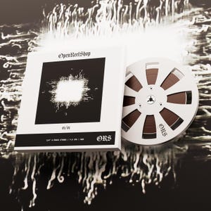 May include: A white box and reel-to-reel tape with the text "OpenReelShop" and "ORS". The box has a black square design with a white center. The reel is brown and white.