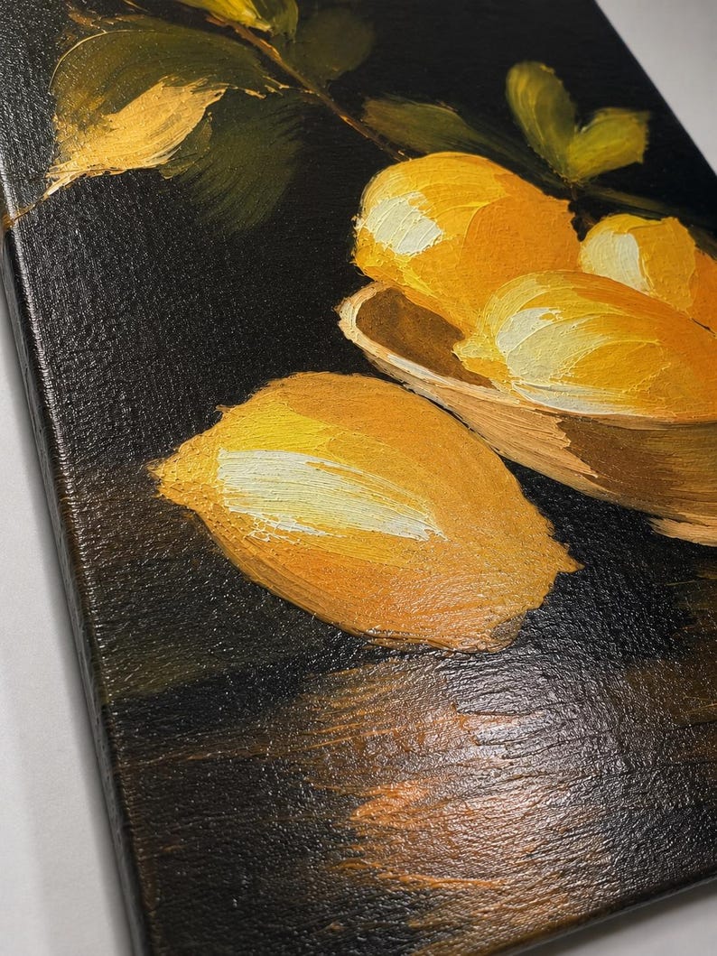 Puede incluir: Una pintura al &oacute;leo sobre lienzo que presenta limones de color amarillo brillante con pinceladas visibles. Varios limones est&aacute;n agrupados en un cuenco poco profundo, mientras que uno descansa sobre una superficie oscura. El fondo es de un negro intenso, contrastando con la fruta amarilla vibrante y las hojas verdes pintadas con una t&eacute;cnica de empaste gruesa y texturizada.
