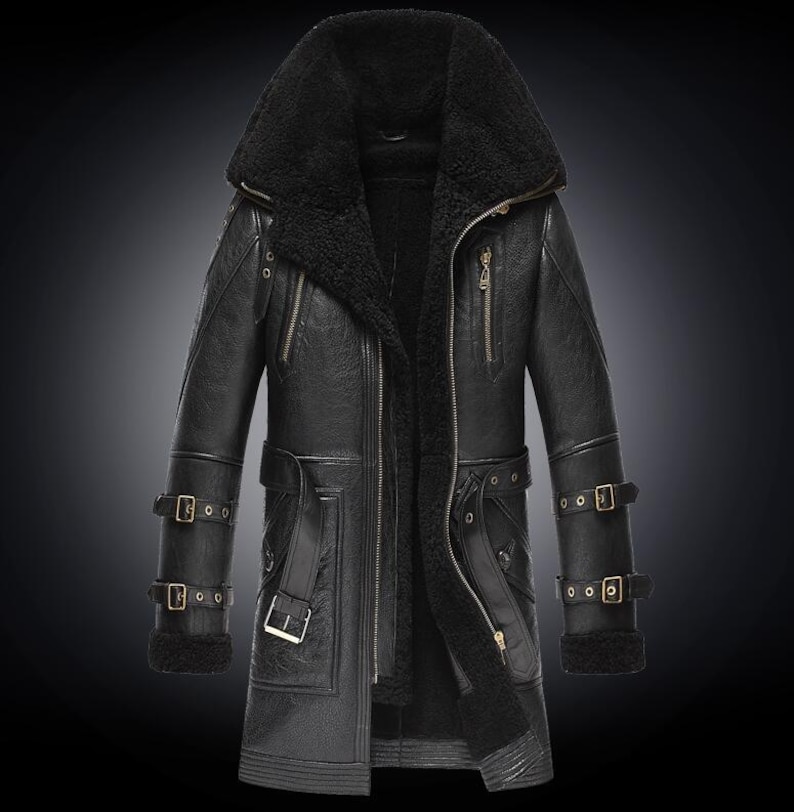 May include: Black leather coat with a large shearling collar and lining. The coat features multiple pockets, a zipper closure, and adjustable buckle straps on the sleeves and waist. The coat is designed for cold weather.
