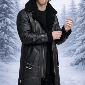May include: Black leather coat with a shearling collar and lining. The coat features multiple pockets, a zip closure, and buckle details. The model is wearing a black sweater and pants. The background is a snowy winter scene.