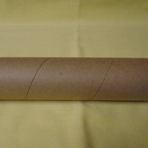 May include: A brown cardboard tube, likely used for shipping or storing rolled items.