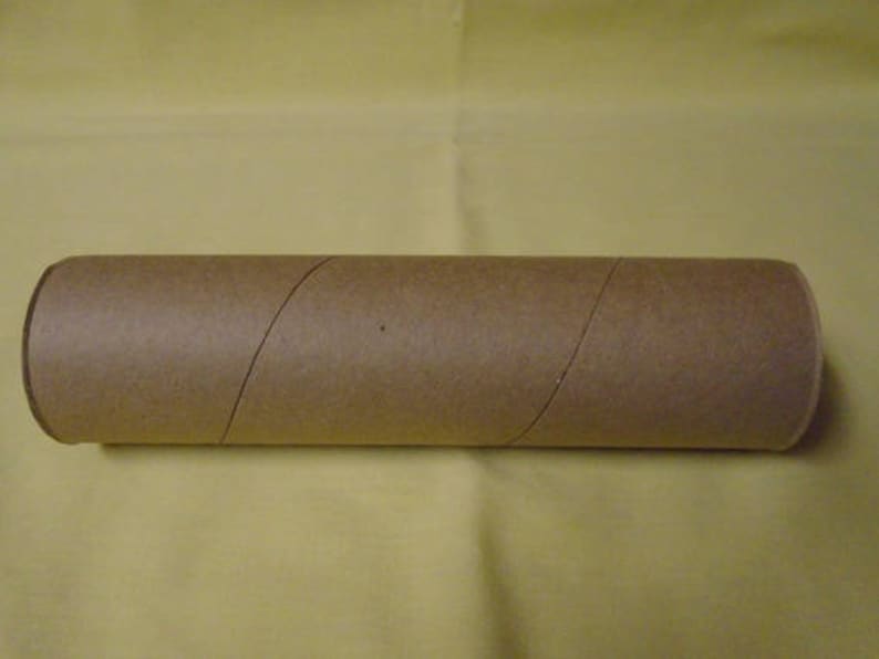 May include: A brown cardboard tube, likely used for shipping or storing rolled items.