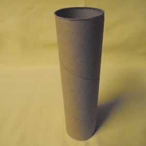 May include: A brown cardboard tube with a slightly textured surface.