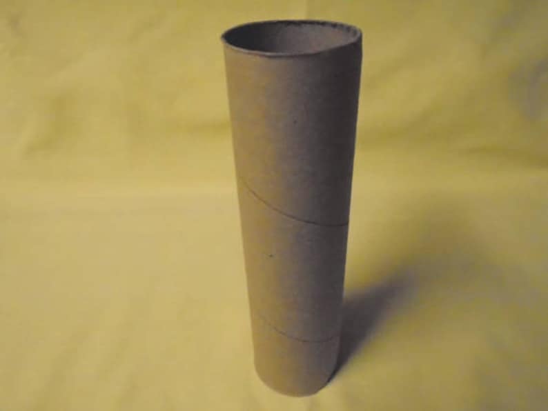 May include: A brown cardboard tube with a slightly textured surface.