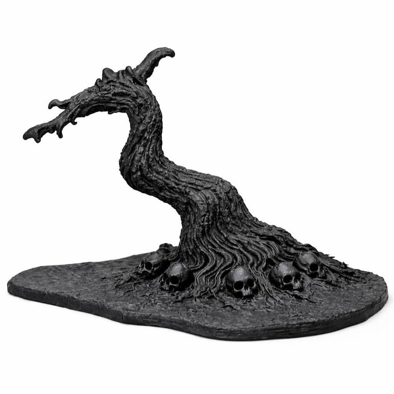 May include: A dark gray, stylized sculpture of a gnarled tree with a curved trunk and branches. The base features several skulls. The sculpture has a textured surface and is set against a white background.