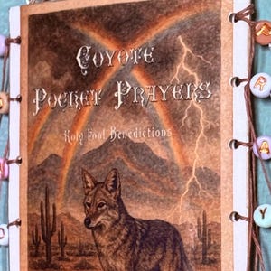 May include: A wall hanging with a printed image of a coyote in a desert scene, with the text "Coyote Pocket Prayers". It is decorated with beaded strands and a hanging cord, suitable for interior decor.