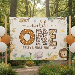 May include: A beige banner with the text "wild ONE" and "HARLEY'S FIRST BIRTHDAY" in brown. The "O" in "ONE" is brown with white spots, and the "N" and "E" have animal print. The banner has jungle animal illustrations.