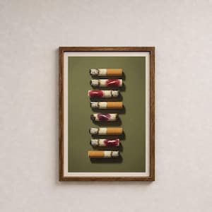 A framed art print featuring a vertical stack of used cigarettes with lipstick marks on a green background.