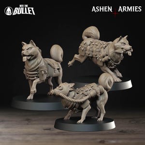 May include: Three gray dog figurines with military-style gear, including harnesses and gas masks. The figurines are on black circular bases. The text "Bite the Bullet" and "Ashen Armies" are visible.