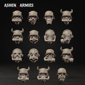 May include: A selection of miniature, detailed, beige-coloured gas mask and helmet designs. The masks feature various styles, including skull-shaped faces and horned helmets. The text "ASHEN ARMIES" is at the top of the image.