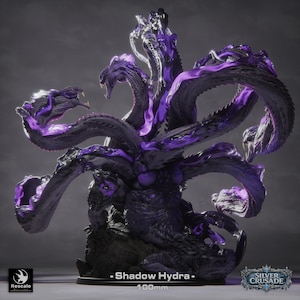 May include: A detailed, dark purple and black Shadow Hydra miniature, a fantasy creature with multiple serpentine heads. The miniature is 100mm tall and features intricate detailing, with the text "Shadow Hydra" and "Silver Crusade" visible.