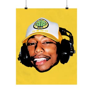 May include: Poster showing a person wearing a white and yellow N.E.R.D. hat with a brain graphic and black headphones against a yellow background. The person is smiling.