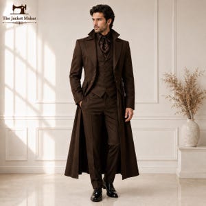 May include: A dark brown three-piece suit consisting of a long trench coat, a button-up vest, and matching trousers. The ensemble features a dark brown cravat worn at the neck. The coat has wide lapels and long sleeves, paired with black dress shoes.