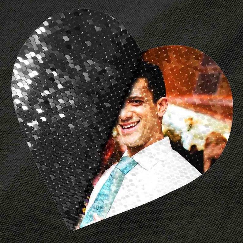 May include: A heart-shaped design. The left side has a black sequined texture, the right side shows a smiling person in a white shirt and blue tie. The background is dark.
