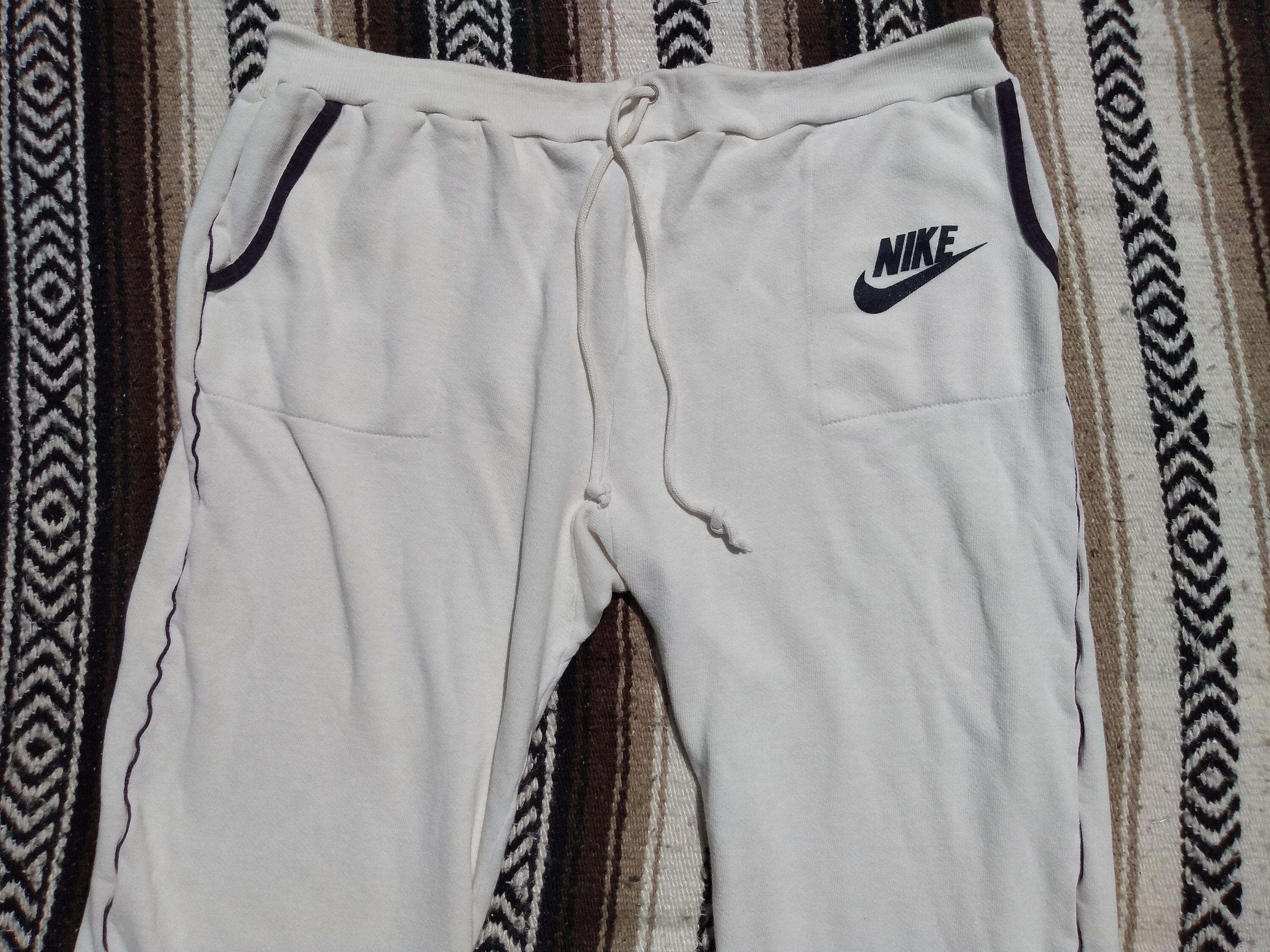 Nike Monogram All Over Logo Print Fleece Cuffed Sweatpants in Pink