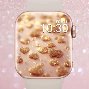 以下が含まれることがあります： 白のバンドが付いたローズゴールドのスマートウォッチ。文字盤には、ピンクの背景に金色のグリッターハートのパターンが表示されています。時刻は10時30分、11日金曜日です。「Luxe Babe」の文字が左上にあります。