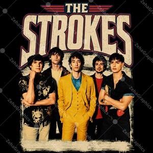 May include: A graphic print featuring the band The Strokes with the text THE STROKES in large beige letters with a red outline. Four band members are shown: one in a black patterned shirt, one in a yellow suit, one in a red shirt, and one in a black shirt.