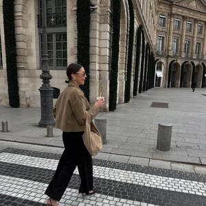 Female model walking in oversized beige leather jacket with neutral minimalist fashion look