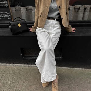 Minimalist outfit featuring beige leather jacket for women with relaxed tailored silhouette