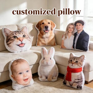 May include: Customized pillows featuring various images, including a cat, dog, baby, rabbit, and a couple. The pillows are shaped to match the images and are arranged on a beige sofa and a carpet. The text "customized pillow" is displayed at the top.