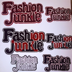 May include: Six embroidered patches featuring the text Fashion Junkie in various color combinations. The top row shows dark red text, the middle row features black and red text, and the bottom row displays light gray and black text designs.
