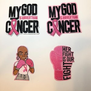 May include: Four embroidered patches with a pink ribbon and text related to cancer awareness. Two patches read "MY GOD IS BIGGER THAN CANCER". One patch features a woman in boxing gloves. The last patch is a pink boxing glove with the text "HER FIGHT IS OUR FIGHT".