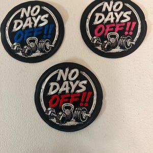 May include: Three circular embroidered patches with black borders. Each patch features the white text NO DAYS, with the word OFF!! in blue, pink, or red. Below the text, each patch displays embroidered illustrations of a dumbbell, kettlebell, and barbell.