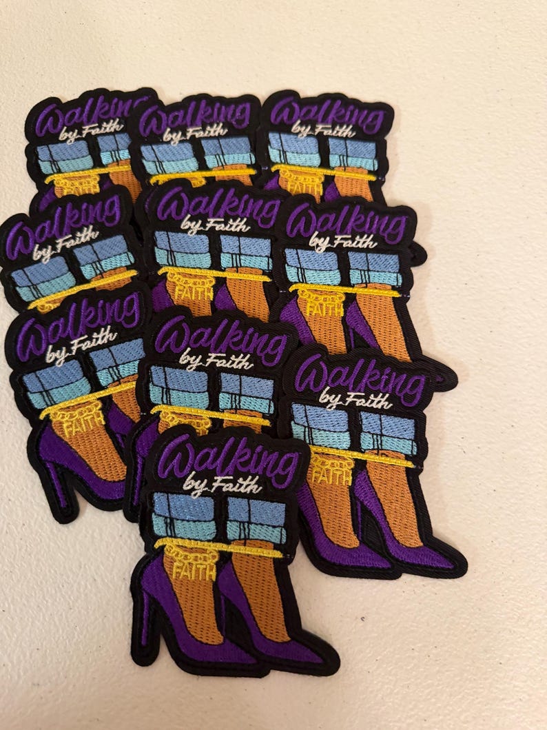 May include: A collection of embroidered patches featuring a pair of purple high-heeled shoes with light blue cuffed jeans and a gold ankle chain that reads FAITH. The text WALKING by Faith is embroidered in purple and white above the shoes.