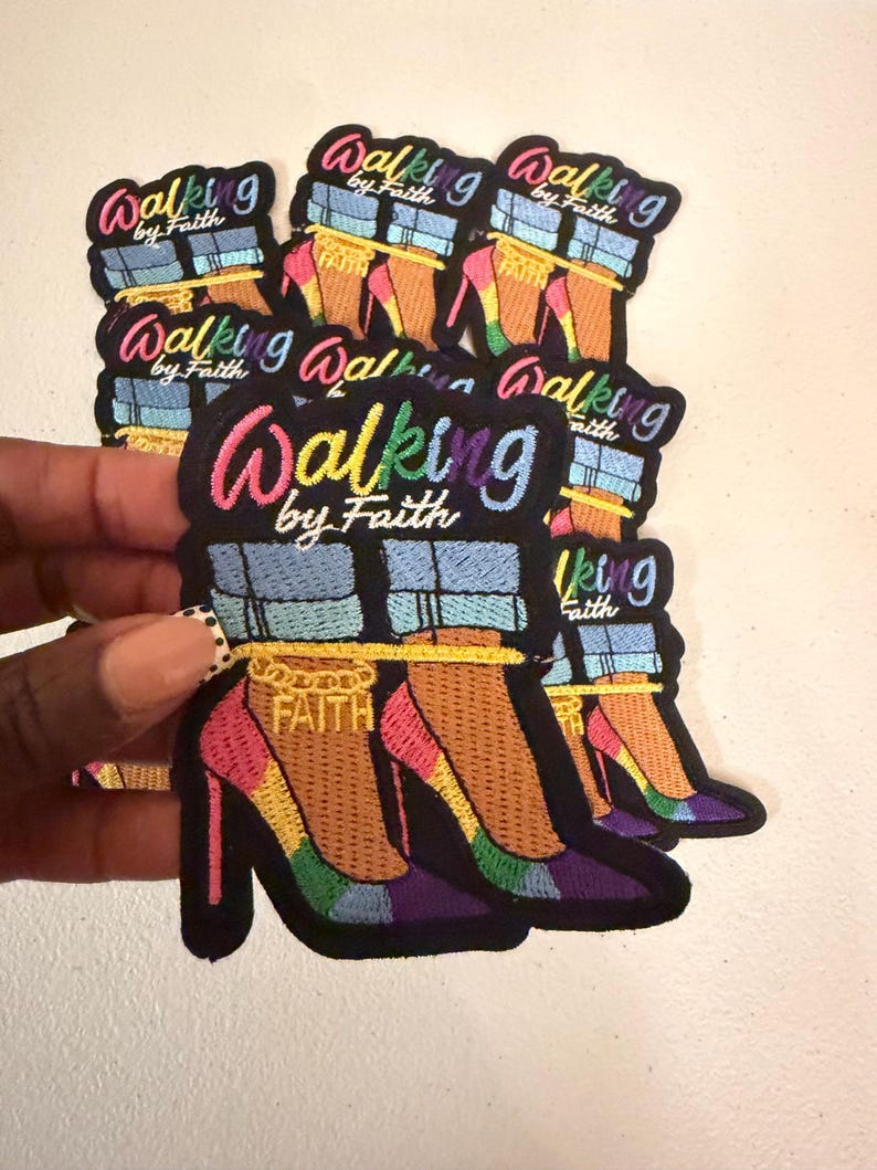 May include: A collection of embroidered patches featuring a pair of high-heeled shoes with light blue denim cuffs, a gold ankle chain with the word FAITH, and the text Walking by Faith in a multi-colored gradient font on a black background.