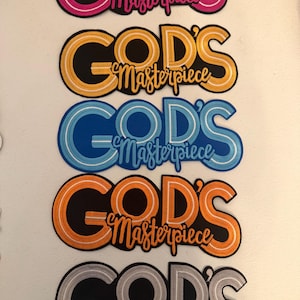 May include: Five embroidered patches with the words "GOD'S Masterpiece" in various colors. The patches include pink, yellow, blue, orange, and silver, each with a black background and a contrasting outline.