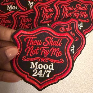May include: Black and red embroidered patches with the text "Thou Shall Not Try Me" and "Mood 24/7". The patches have a shield shape with a red border and decorative elements.