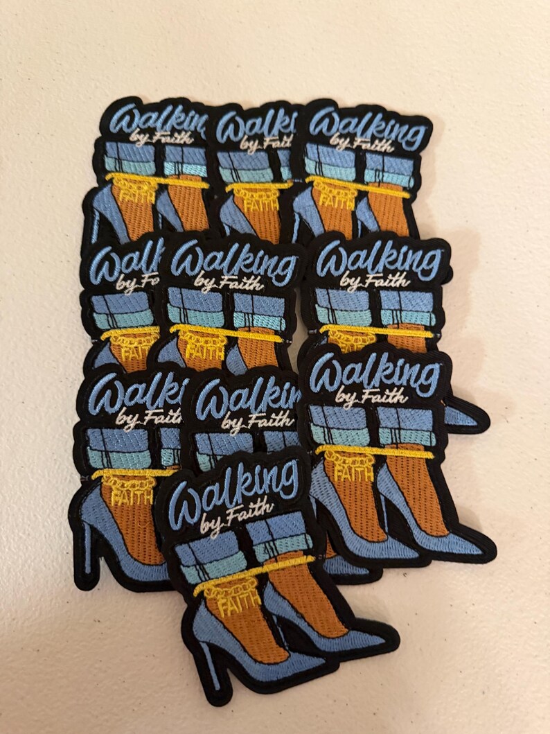 May include: A collection of embroidered patches featuring a pair of light blue high-heeled shoes with cuffed blue jeans, a yellow ankle chain with the word FAITH, and the text Walking by Faith in light blue script lettering on a black background.