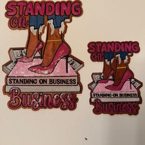 May include: A set of three ceramic canisters with lids. The canisters are white with a blue floral pattern. The largest canister is 8 inches tall, the medium is 7 inches, and the smallest is 6 inches.