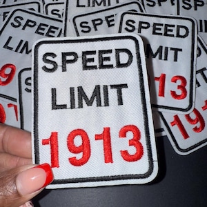 May include: White embroidered patch with black border featuring the words "SPEED LIMIT" and the number "1913" in red. The patches are rectangular and have a black border. The image shows a collection of these patches.