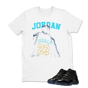 May include: White t-shirt with the word "JORDAN" in light blue and a graphic of a basketball player's jersey with the number 23. Black and blue athletic shoes are at the bottom of the image.