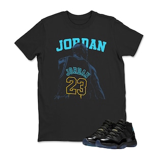 May include: Black t-shirt with the word "JORDAN" in light blue and a graphic of a basketball player's jersey with the number 23. Black and blue sneakers are at the bottom of the image.