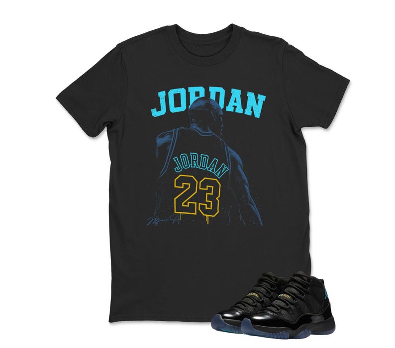 May include: Black t-shirt with the word "JORDAN" in light blue and a graphic of a basketball player's jersey with the number 23. Black and blue sneakers are at the bottom of the image.