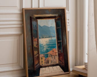 May include: A framed oil painting depicting an open window view of a coastal town with terracotta rooftops, a blue sea reflecting sunlight, and distant mountains. The artwork features dark brown window frames and a light-colored stone balcony floor.