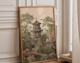Op de afbeelding: Een ingelijste kunstdruk met een pagode met meerdere verdiepingen, genesteld in een weelderig landschap van groene bomen en roze bloeiende struiken. De scène bevat verschillende kleine vogels in de vlucht tegen een zachte perzikkleurige lucht.