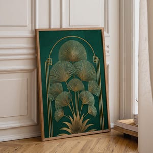 May include: A framed art print featuring a stylized botanical design. The artwork showcases a cluster of fan-shaped leaves in gold against a deep green background. The frame is made of light-colored wood, adding a natural touch.