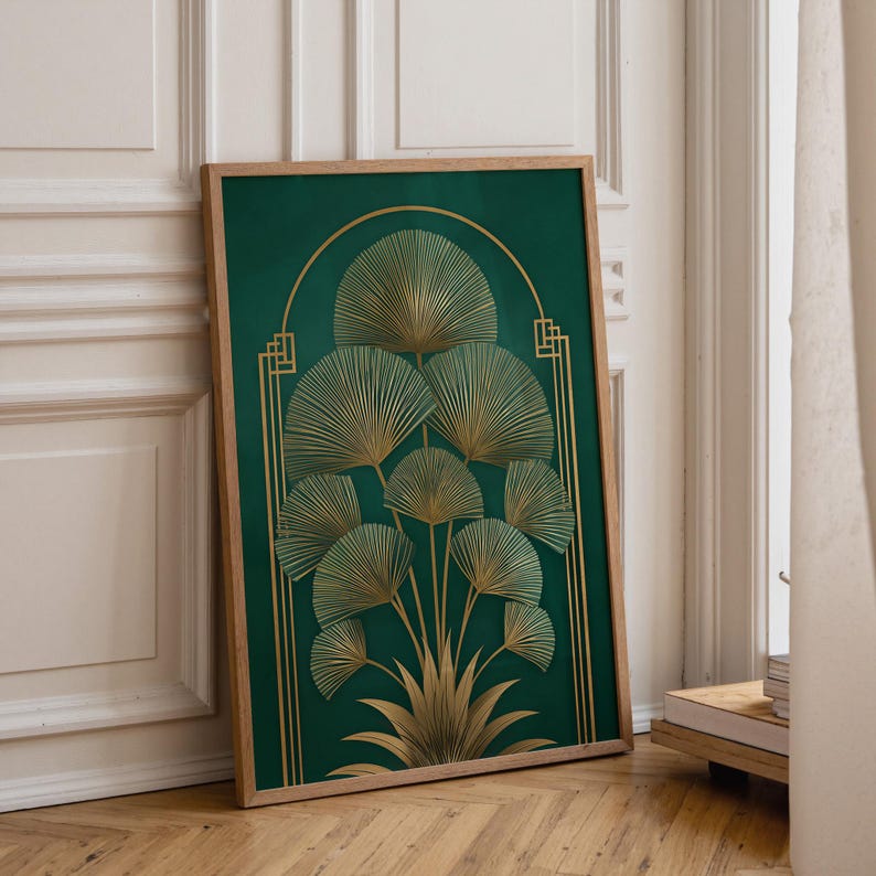 May include: A framed art print featuring a stylized botanical design. The artwork showcases a cluster of fan-shaped leaves in gold against a deep green background. The frame is made of light-colored wood, adding a natural touch.