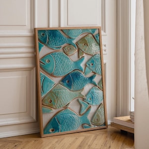 May include: A framed wall art piece featuring a collection of ceramic fish in shades of teal and turquoise. The fish are arranged on a neutral background, with a wooden frame. The artwork adds a coastal or nautical theme to any room.
