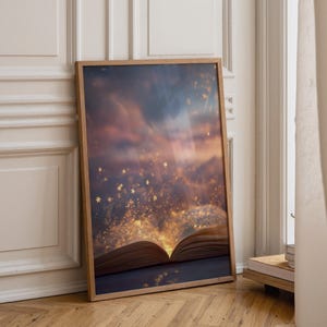 May include: A rectangular framed wall art print featuring an open book with glowing golden light and floating star-shaped particles emanating from the pages against a dark, moody sky with purple and orange clouds in a twilight setting.