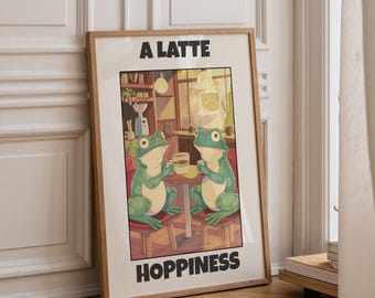 May include: A framed rectangular art print featuring an illustration of two green frogs sitting at a small table in a cafe, each holding a white mug. The text A LATTE is printed above the illustration and HOPPINESS is printed below in black.