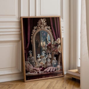 May include: A framed print featuring an ornate oval mirror with a gold frame, set against deep burgundy curtains. The scene includes several glass perfume bottles, a pair of light pink gloves, and a string of pearls resting on a dark wooden surface.